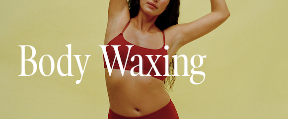 Woman in a two piece clothing set modeling body waxing