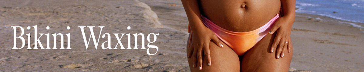 Bikini-clad woman at the beach modeling bikini waxing