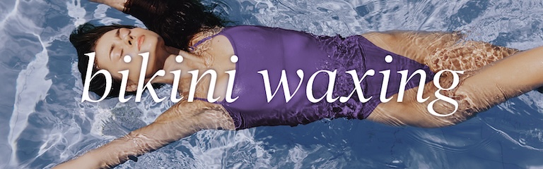 Bikini-clad woman at the beach modeling bikini waxing